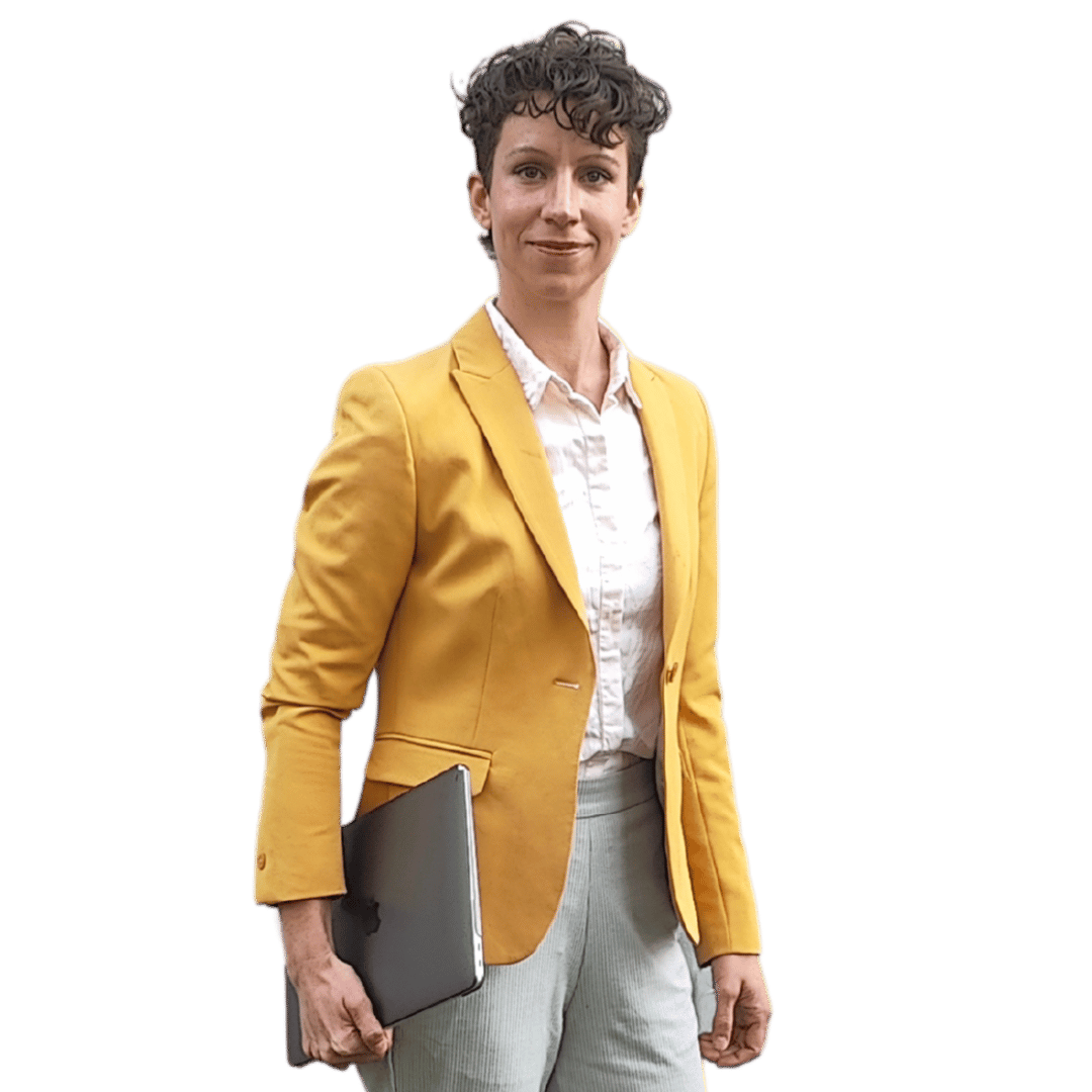 Women in yellow, white, and grey business dress holding a laptop